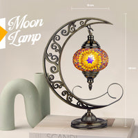 Decorative moon-shaped lamp with mosaic design on a light background